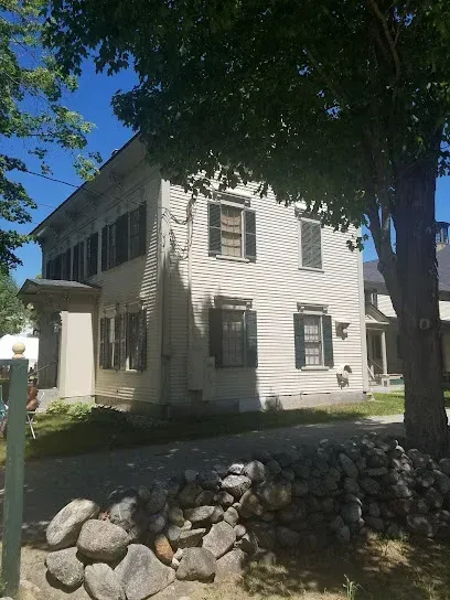 Chimney-Sweep-Portland-Tranquil lake reflects a forest shoreline under a partly cloudy sky.