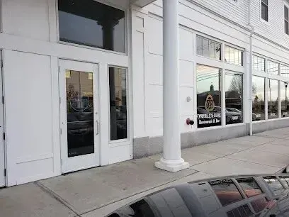 Chimney-Sweep-Portland-A white building with a lot of windows and a car parked in front of it.