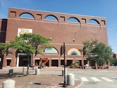Chimney-Sweep-Portland-A large brick building with a rainbow in front of it