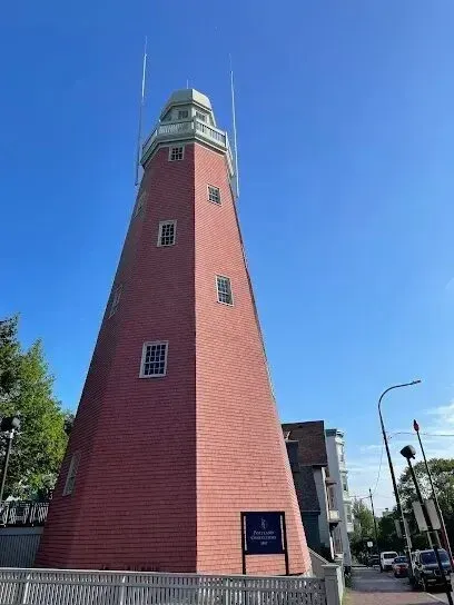 Chimney-Sweep-Portland-A red lighthouse with a blue sky in the background