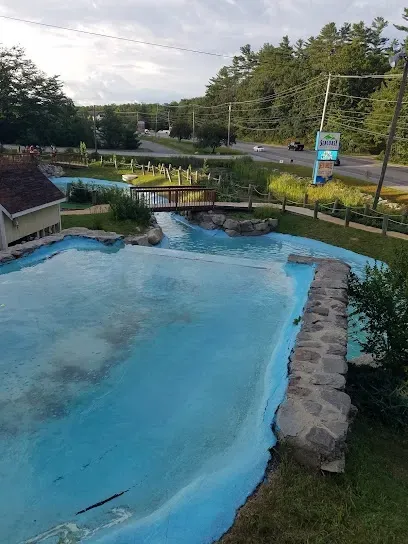 Chimney-Sweep-Portland-Water feature and miniature golf course with a wooden bridge and a roadside sign under a cloudy sky.