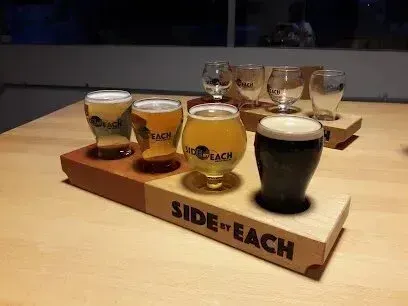 Chimney-Sweep-Portland-A wooden tray with four glasses of beer on it.