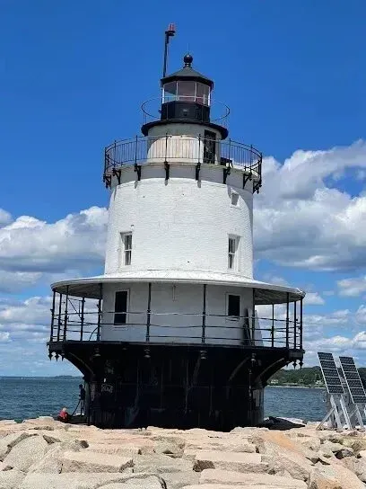Chimney-Sweep-Portland
A large white lighthouse sits on the shore of a body of water