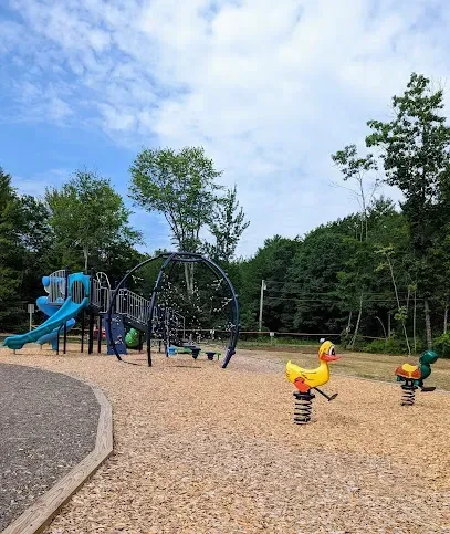 Chimney-Sweep-Portland-A solitary figure ice skates on a rink under a high, industrial ceiling with bright overhead lights.