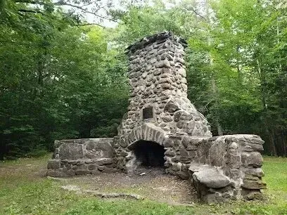 Chimney-Sweep-Portland-A large stone fireplace in the middle of a forest.
