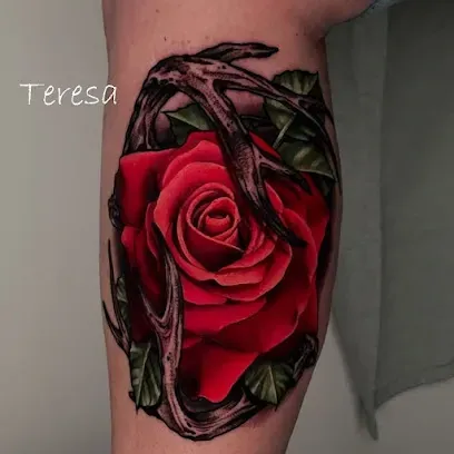 Red rose tattoo with dark thorn details on forearm
