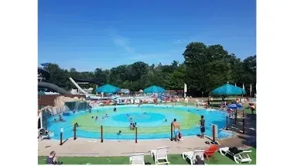 Chimney-Sweep-Portland- Outdoor water park with a large pool, water slide, and people swimming on a sunny day.