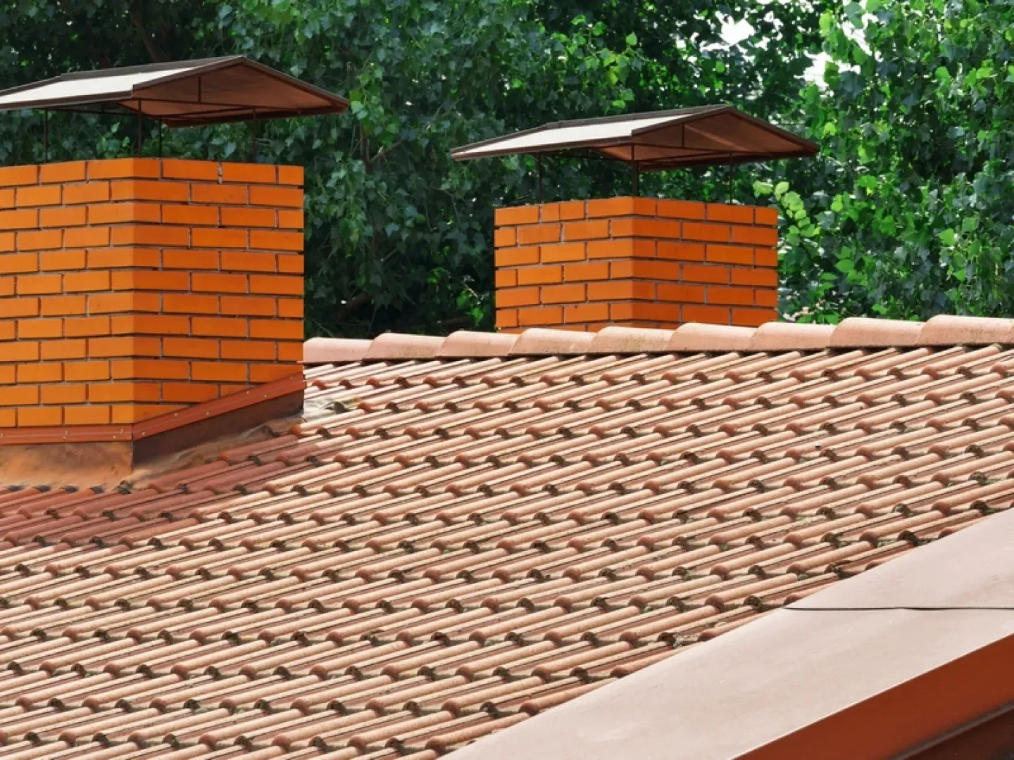 A brick chimney on the roof of a house