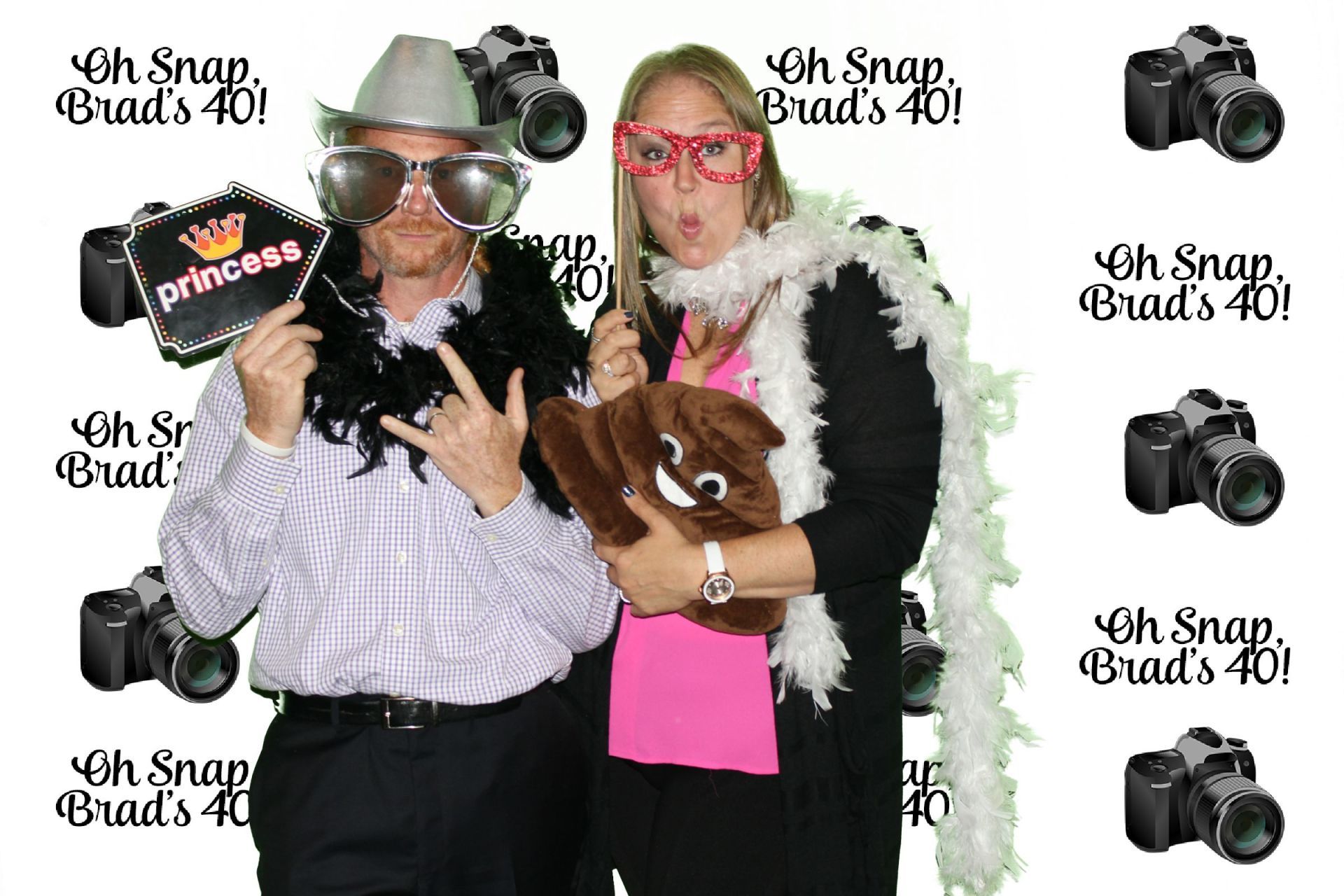 A man and a woman are posing for a picture in a photo booth.