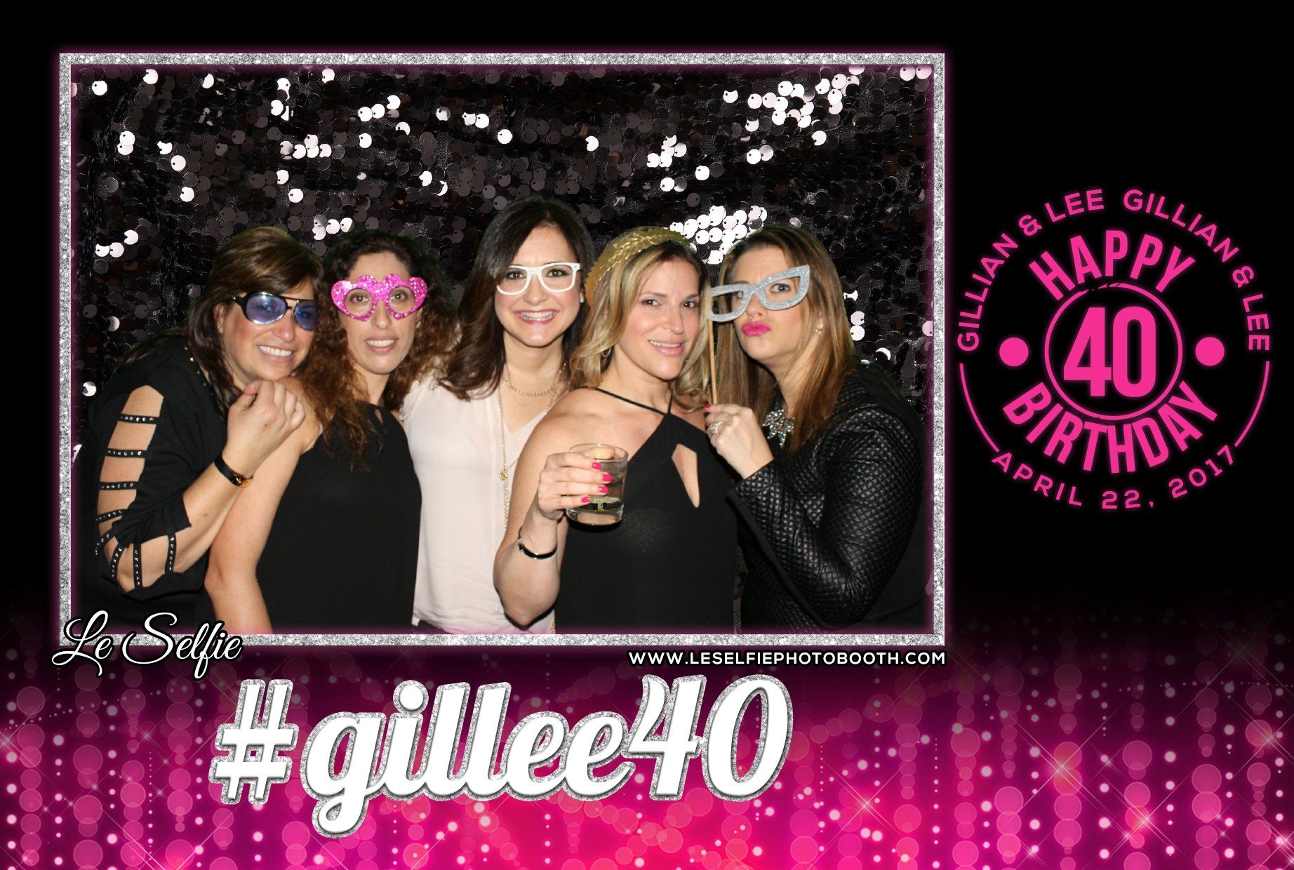 A group of women are posing for a picture in a photo booth for a 40th birthday.