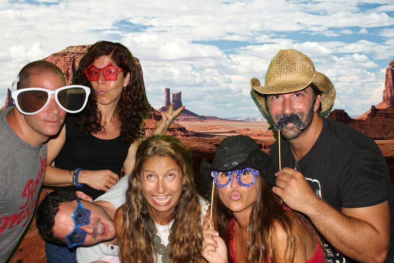 A group of people are posing for a picture in front of a desert background.