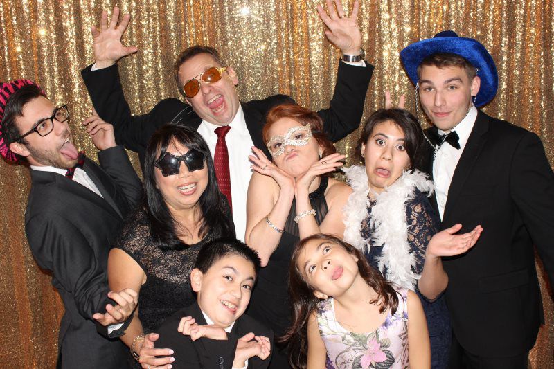 A group of people are posing for a picture in a photo booth.