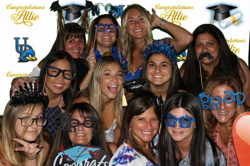 A group of women are posing for a picture in a photo booth.
