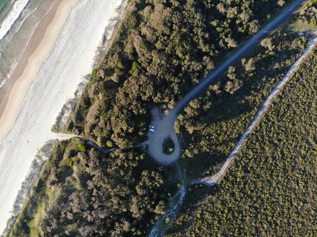 An Aerial View Of A Road Surrounded By Trees And A Beach — NJP Services In Nowra, NSW