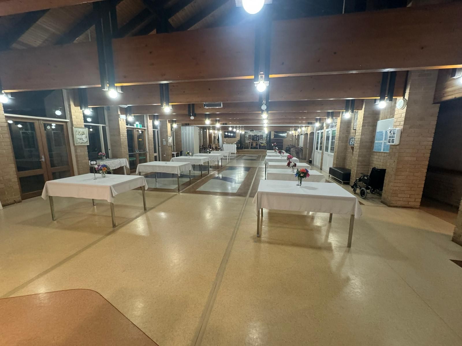 A Person Wearing Pink Gloves Is Cleaning A Desk With A Cloth — NJP Services In Coniston, NSW