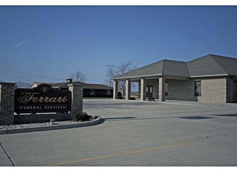 Ferrari Funeral Services building with sign on a sunny day.