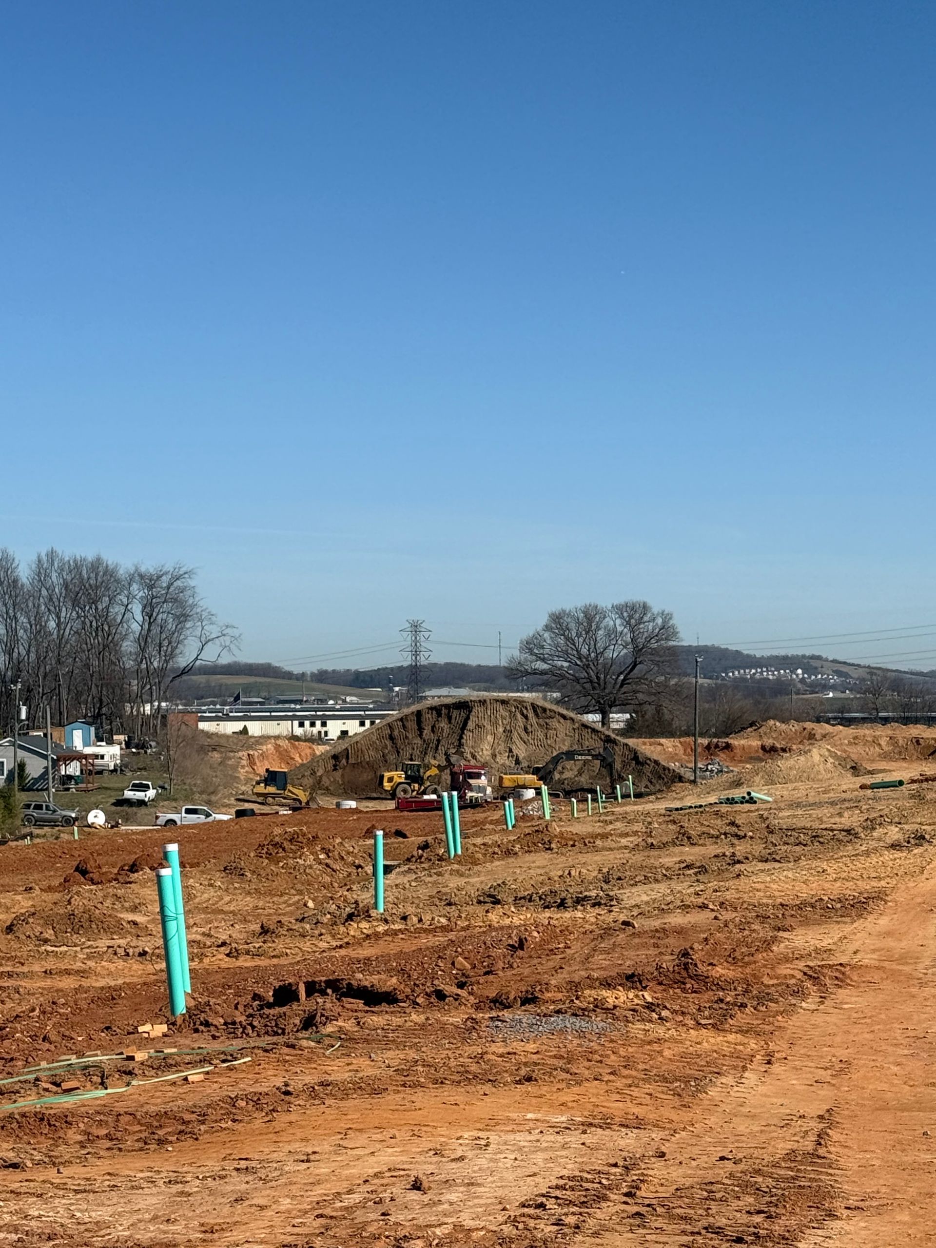 A large concrete foundation is being built on a construction site.