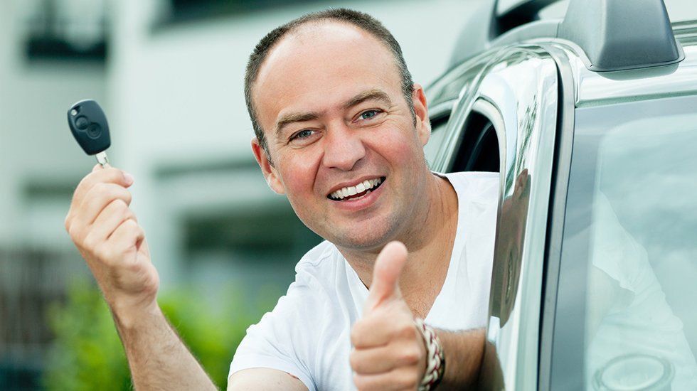 A man holding a car key