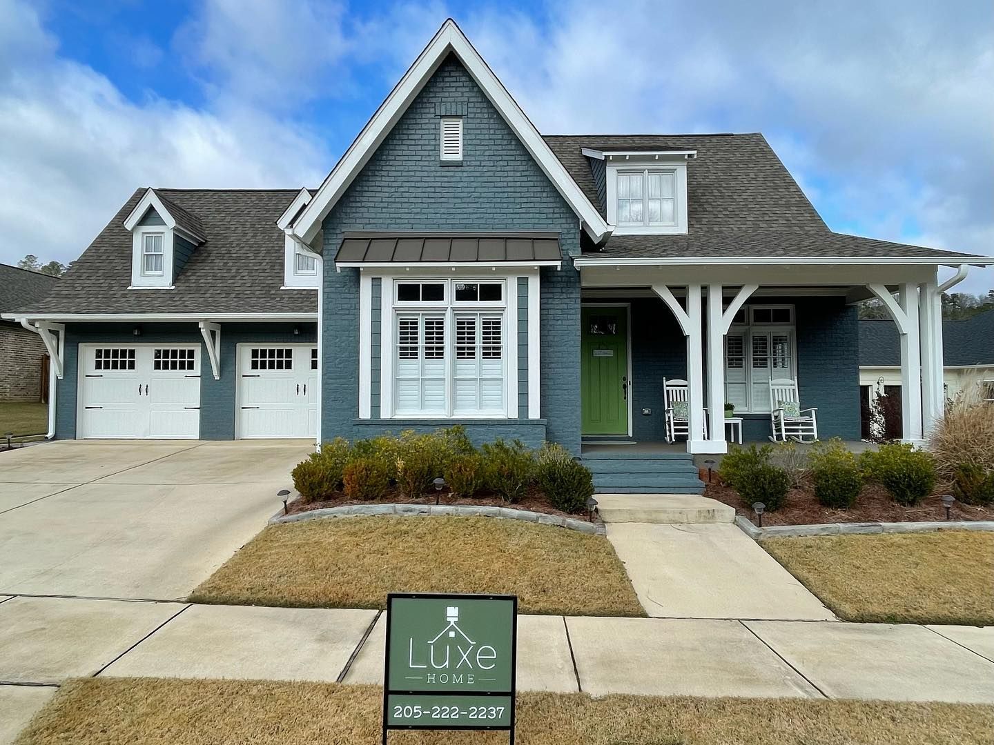 A house with a for sale sign in front of it