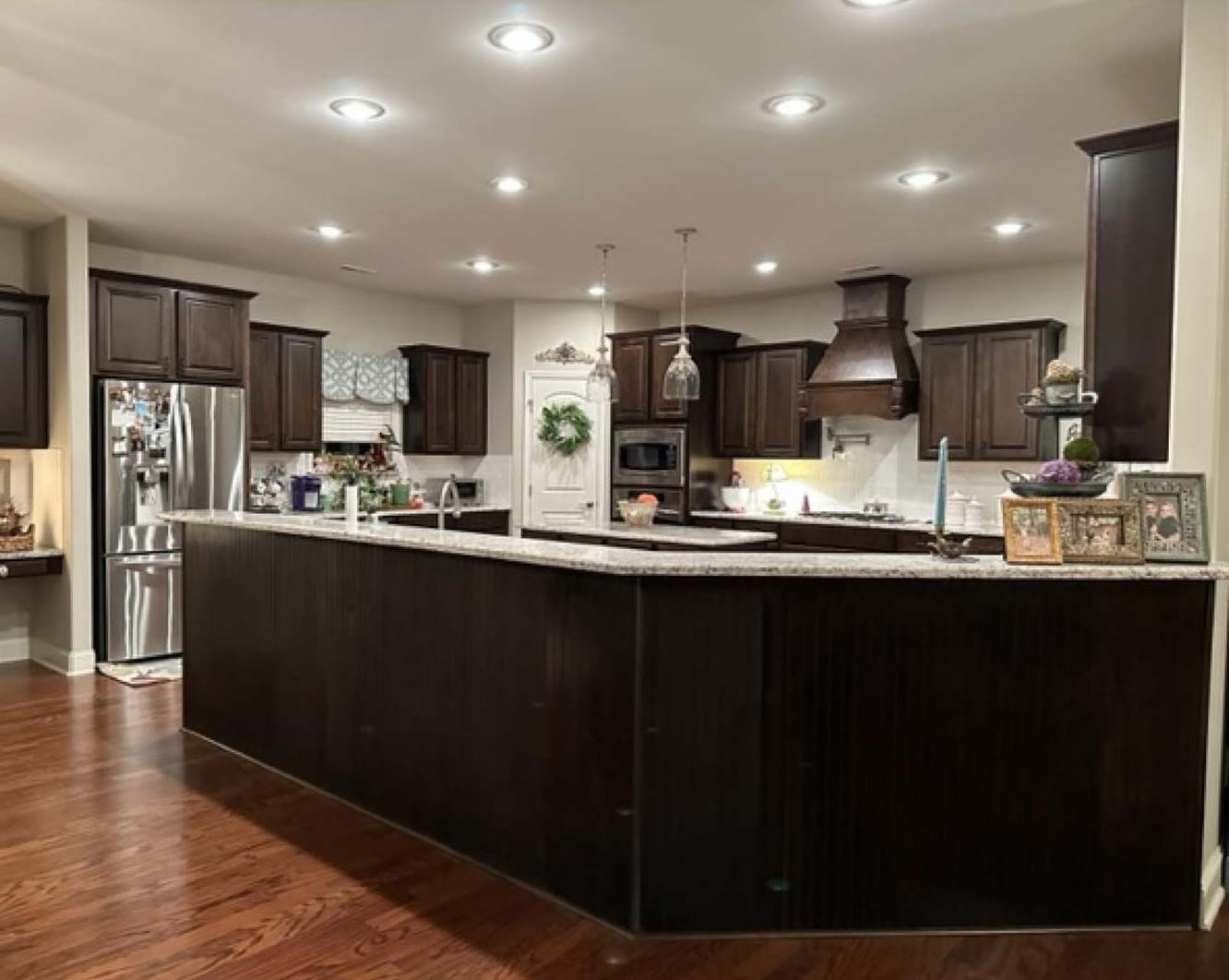 A kitchen with a large island and stainless steel appliances