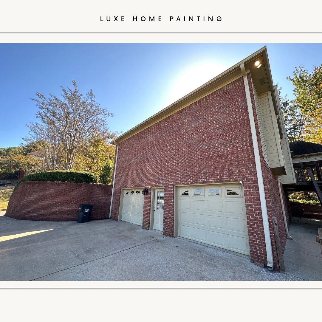 A picture of a brick building with two garage doors
