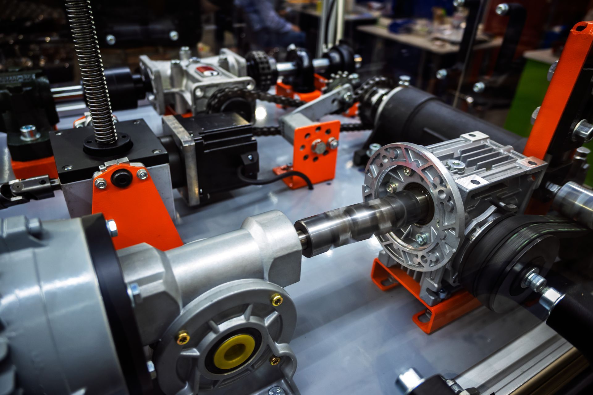 Close-up of complex mechanical gears and components in various colors, possibly a machine part display.