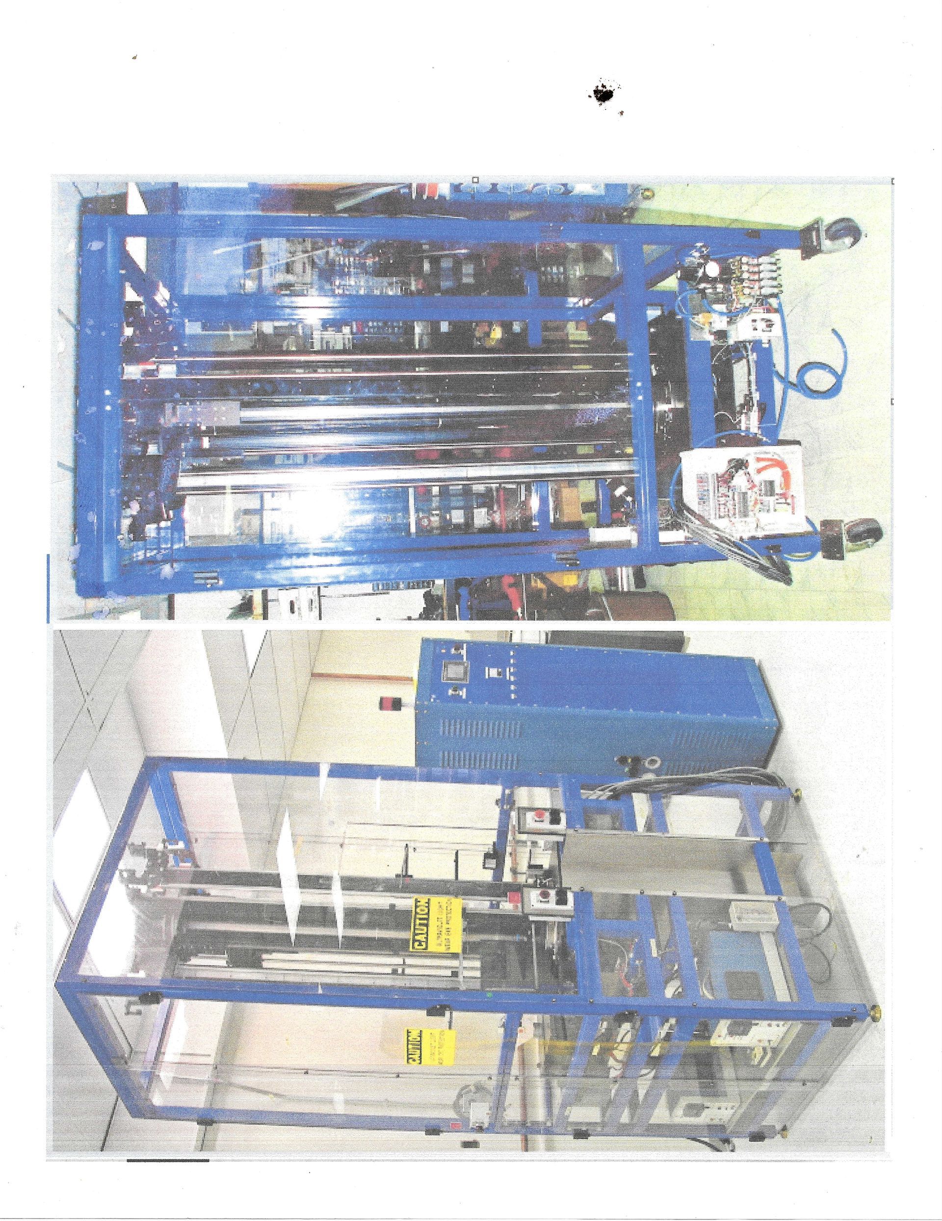 Mechanic in blue overalls working on a blue tractor engine in a workshop.