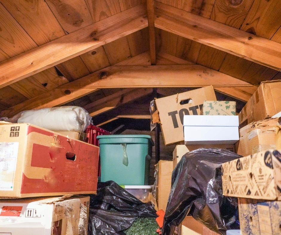 An attic filled with lots of boxes and bags.