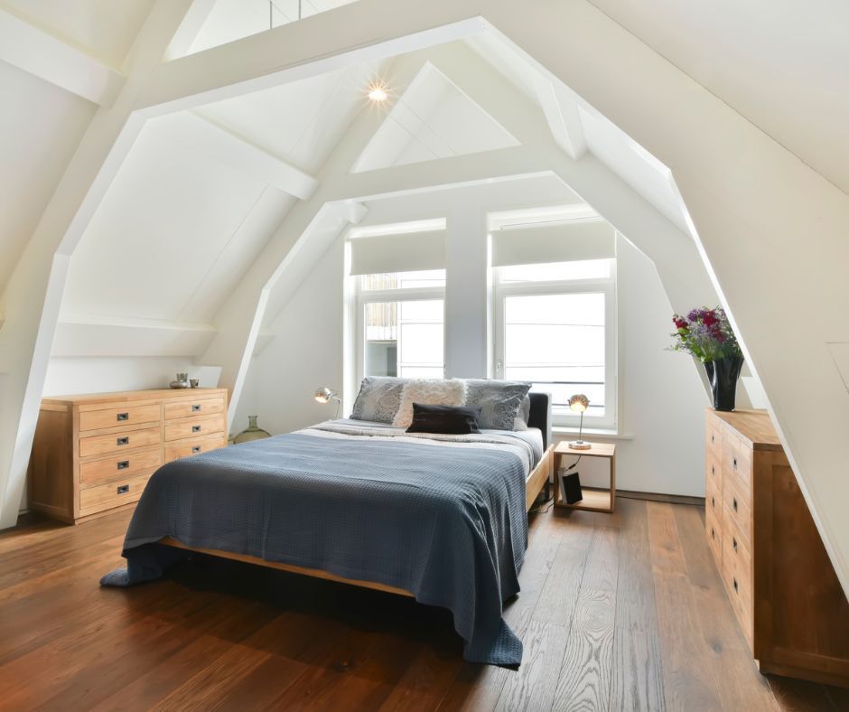 A bedroom with a large bed and lots of windows