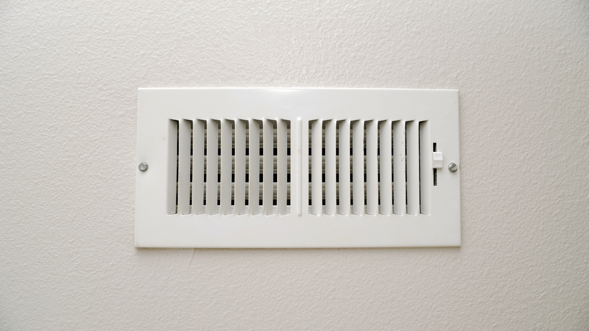 Picture of a white air vent cover on a wall.
