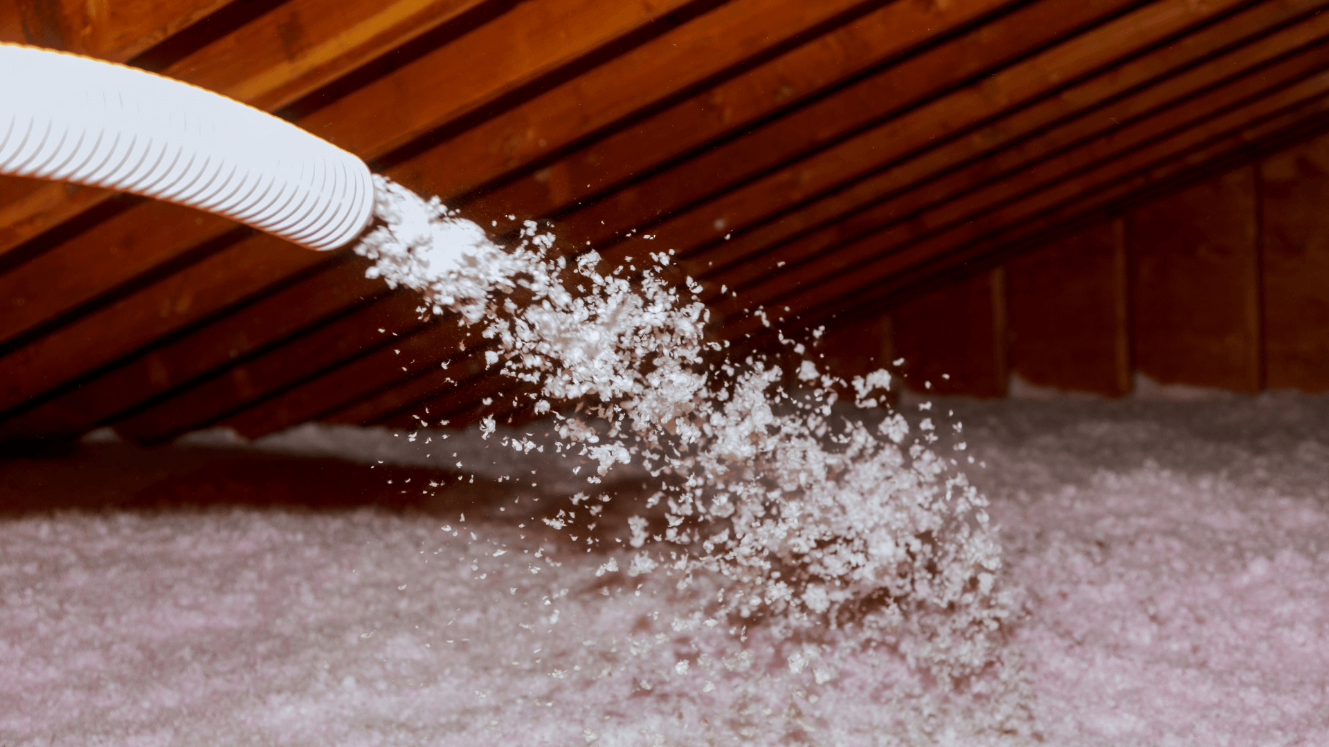 Picture of insulation being blown into the attic.