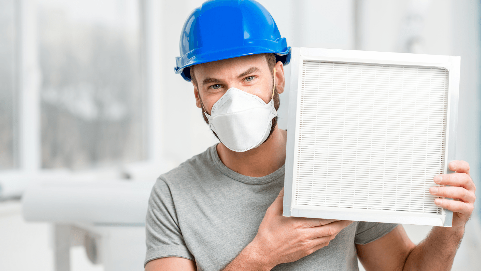 Picture of a man holding up a clean air filter.