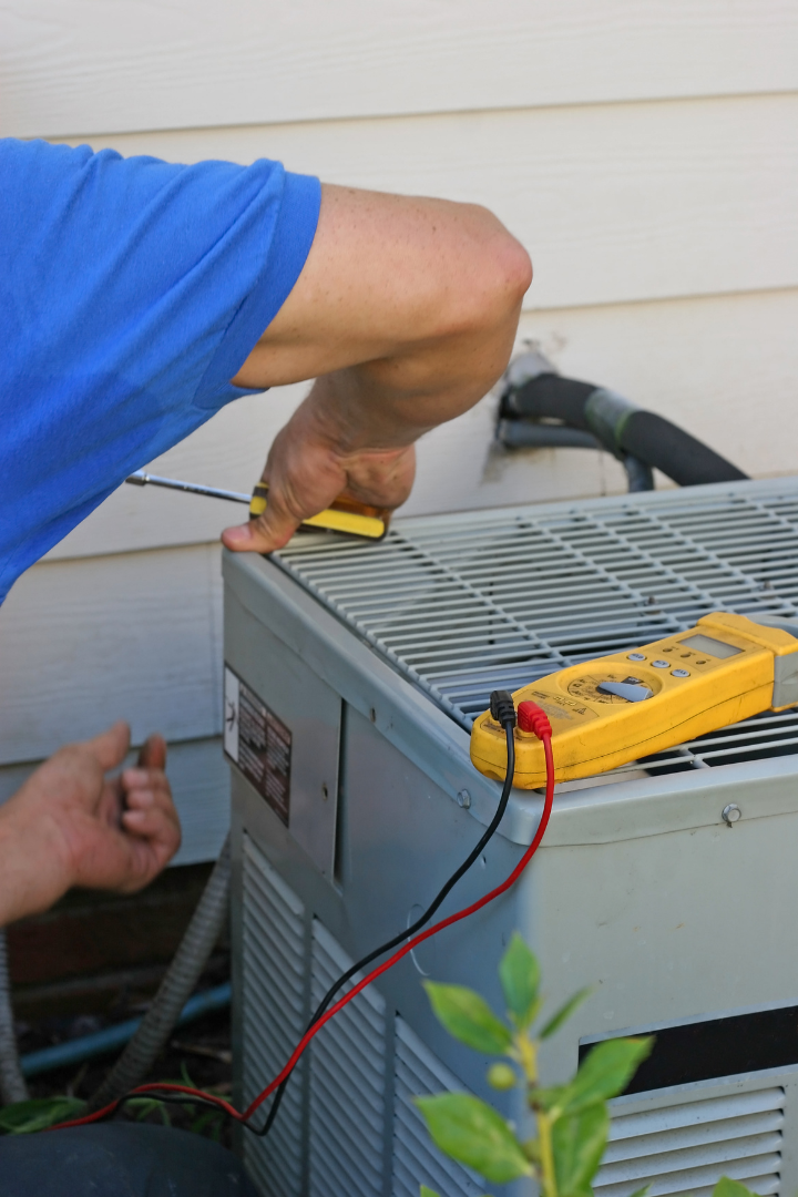 picture of a person fixing an air conditioner