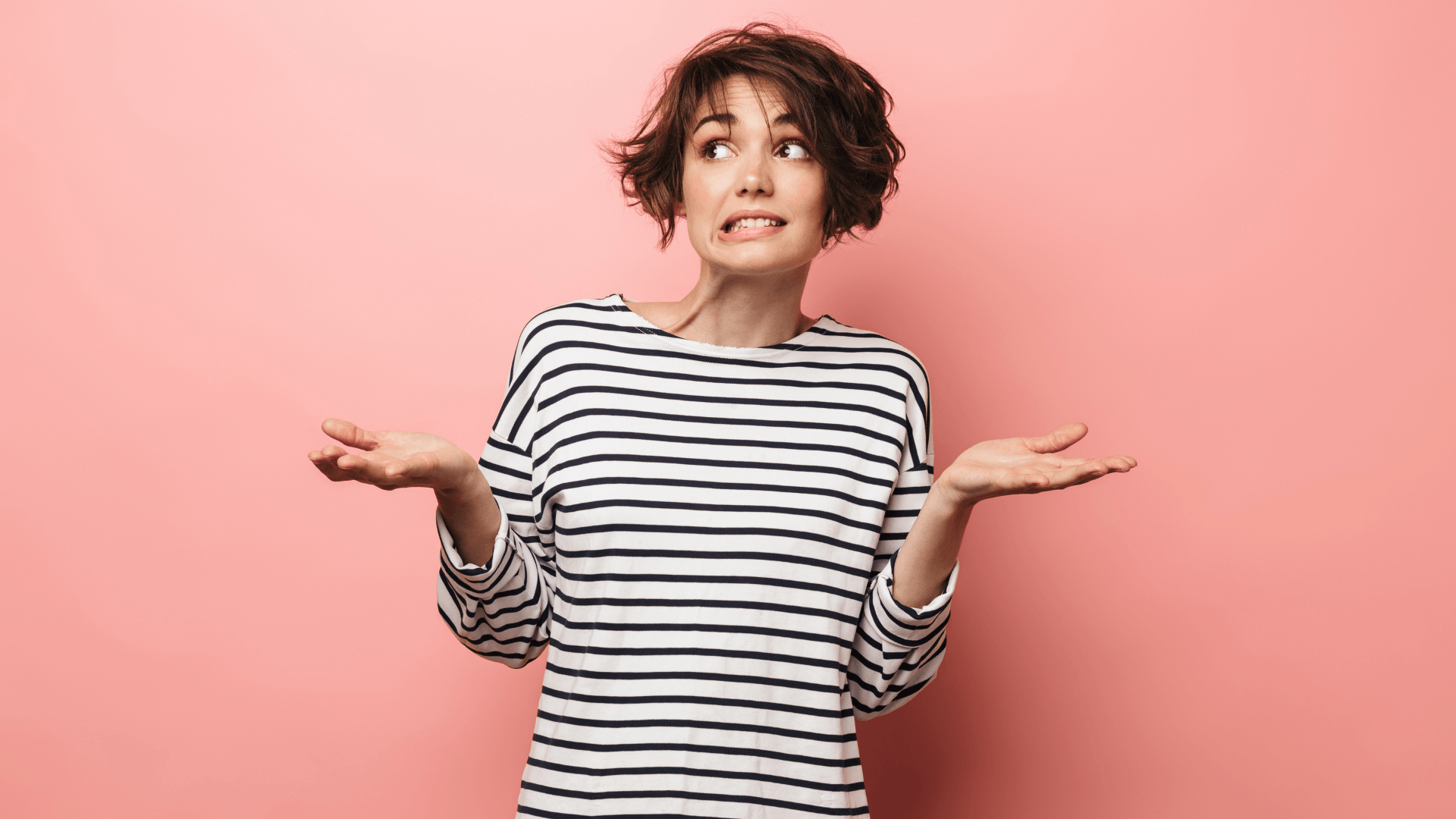 Picture of a women looking really confused with short brown hair.
