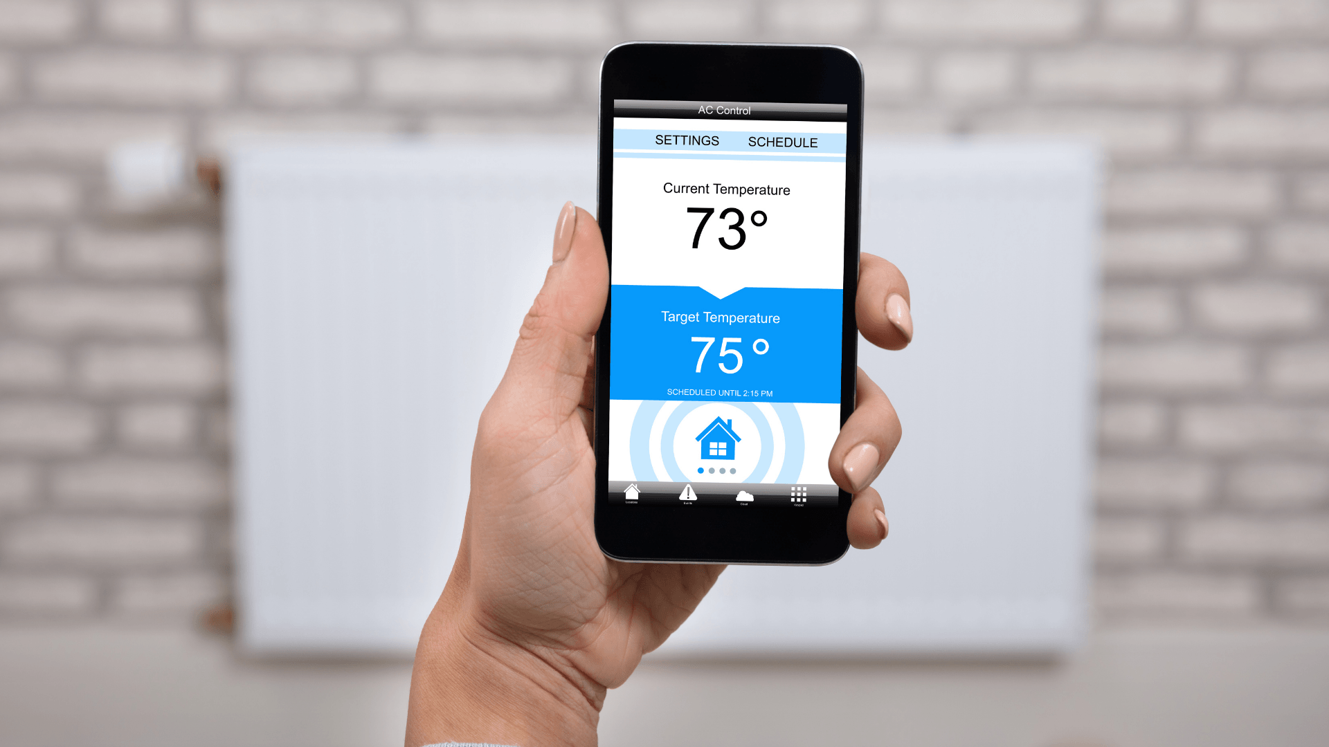 Picture of a smart phone with app that controls the house temperature.