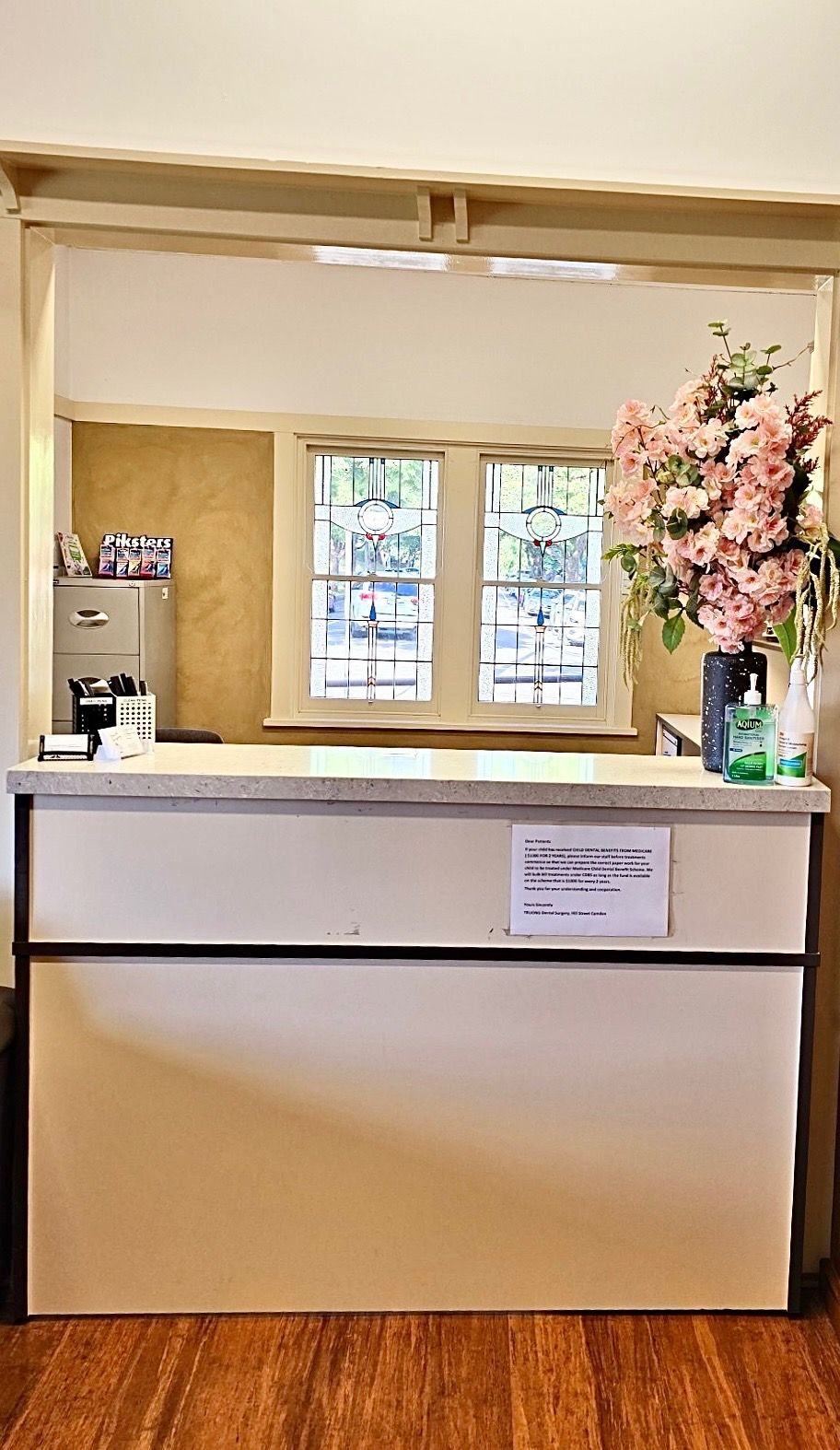 A reception desk in a dental office with flowers on it.