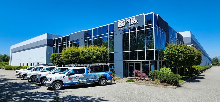 Interlock Metal Roofing fleet of installations trucks in-front of the manufacturing facility in Delta, BC Canada