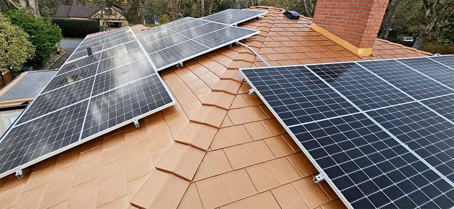 Copper Penny Interlock Metal Slate Roofing System with Solar Panels installed.