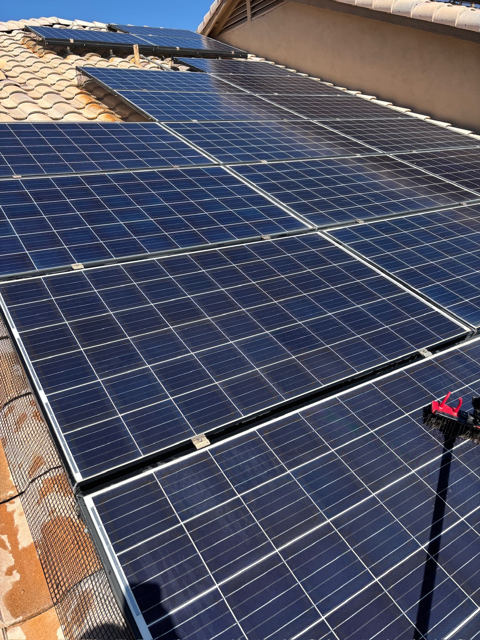 Valley Pro Power Wash cleaning dusty solar panels on a Phoenix home to help improve solar panel effi