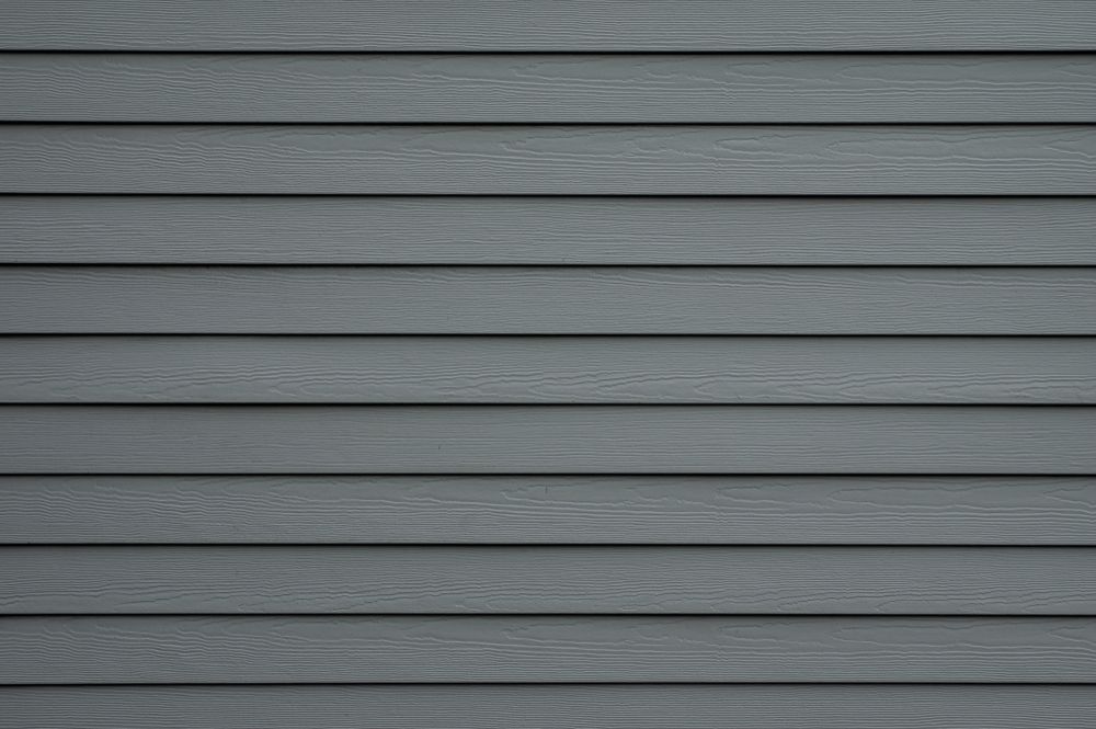 A close up of a gray siding on a house.