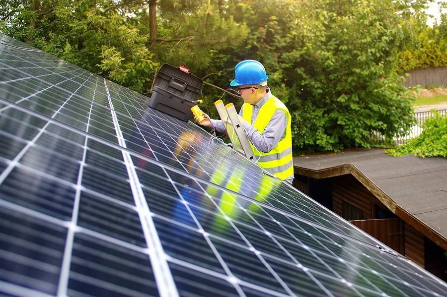 a man working on a solar panel on a roof