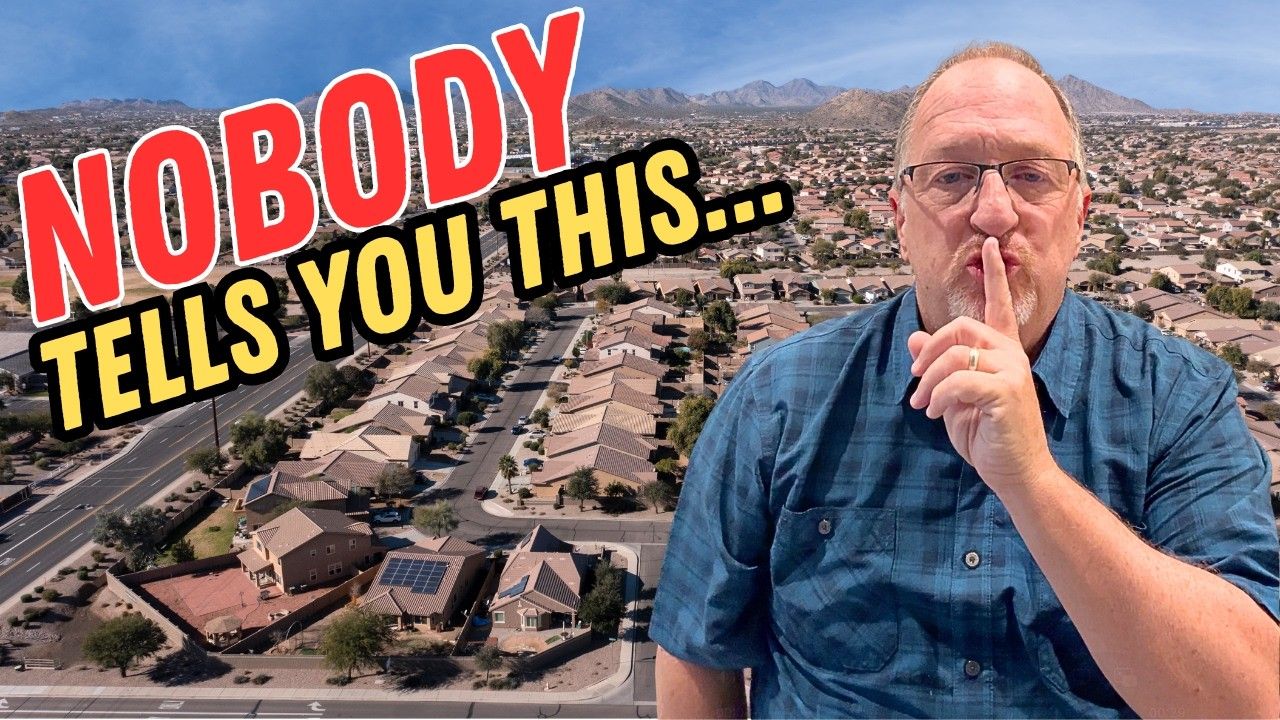 A person in a blue shirt holds a finger to their lips in a shushing gesture over a suburban neighborhood background.