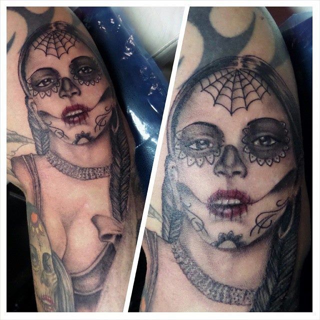 Two tattoo views: A woman's portrait in a Day of the Dead style. Features a spiderweb headpiece and face makeup.