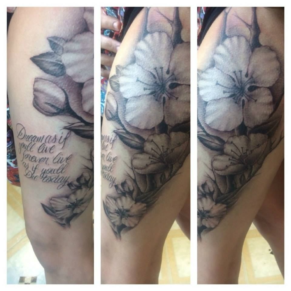Tattoo of white cherry blossoms with script 