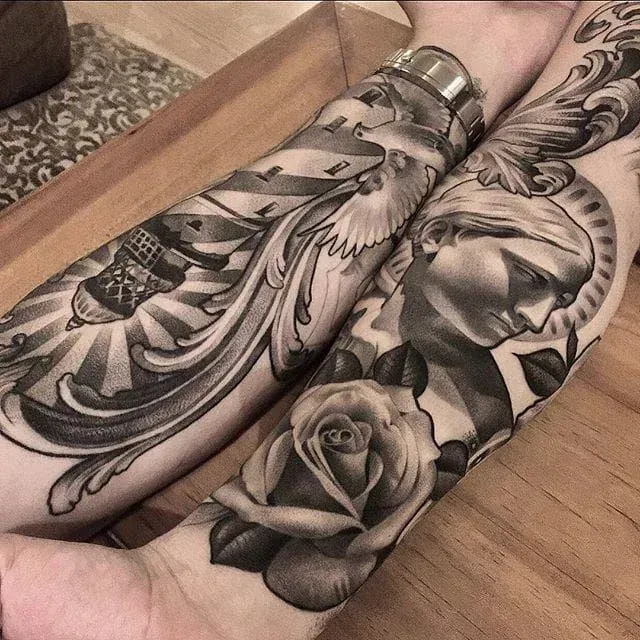 Two arms with detailed black and gray sleeve tattoos featuring architectural elements, a dove, a statue, and a rose.