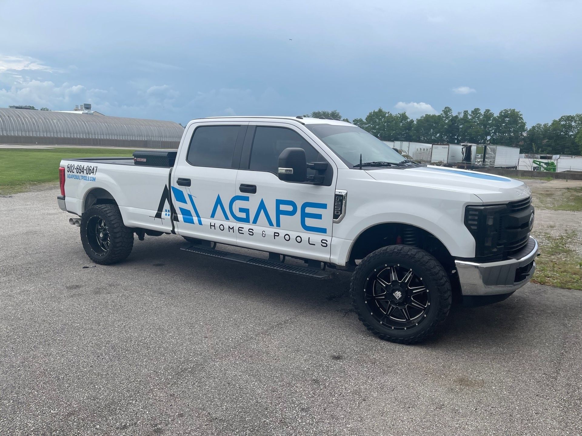 A white pickup truck is parked on the side of the road.
