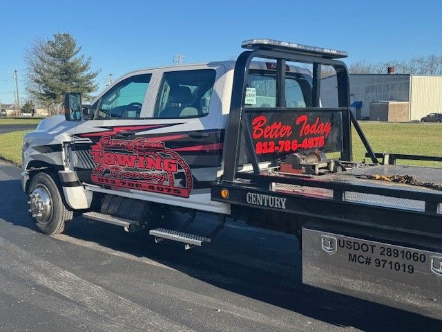 A tow truck is parked on the side of the road.