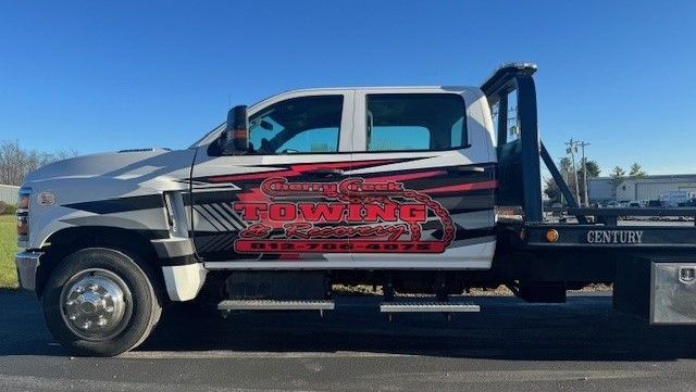 A tow truck is parked on the side of the road.