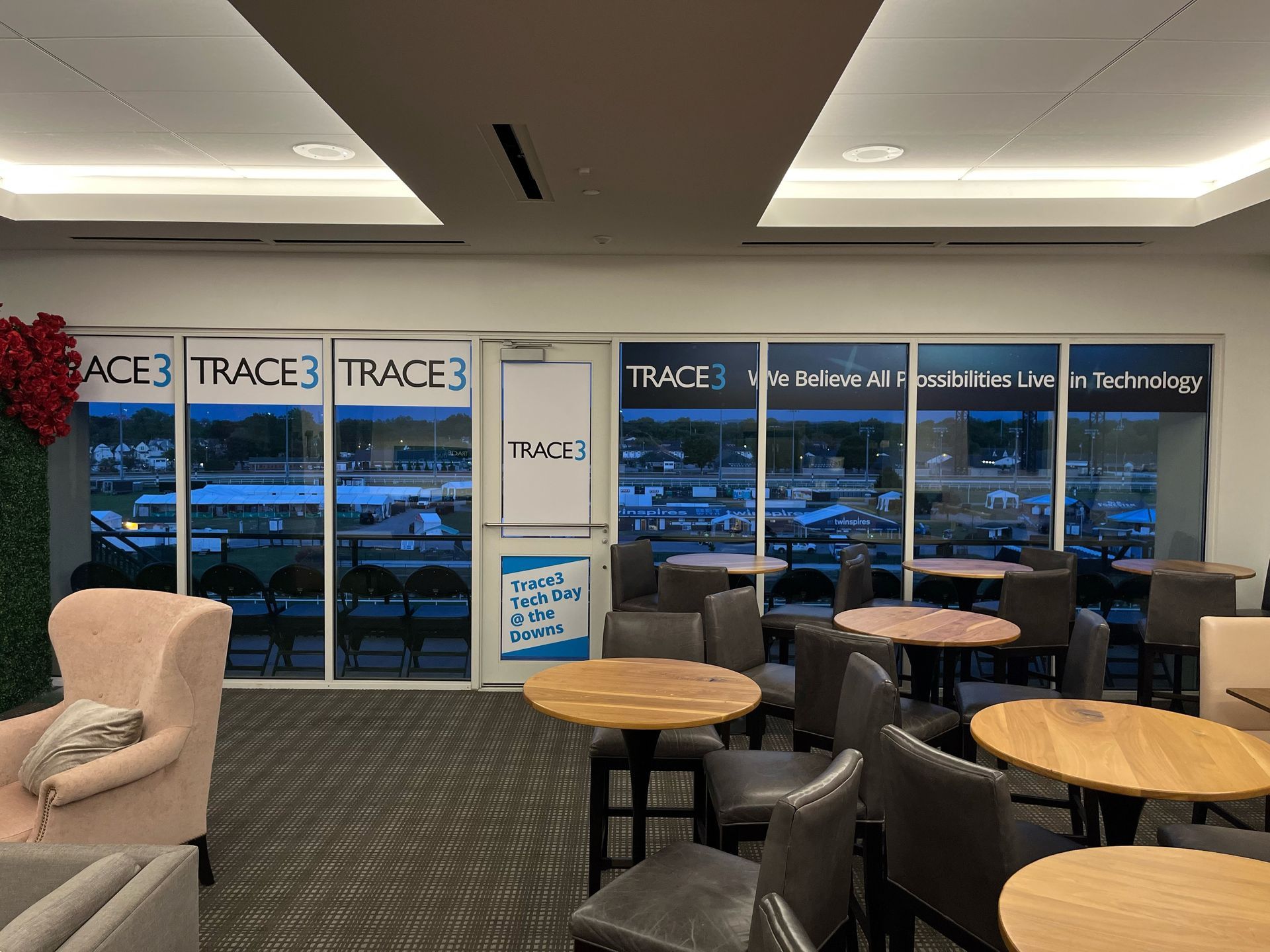 A room with tables and chairs and a sign that says trace 3
