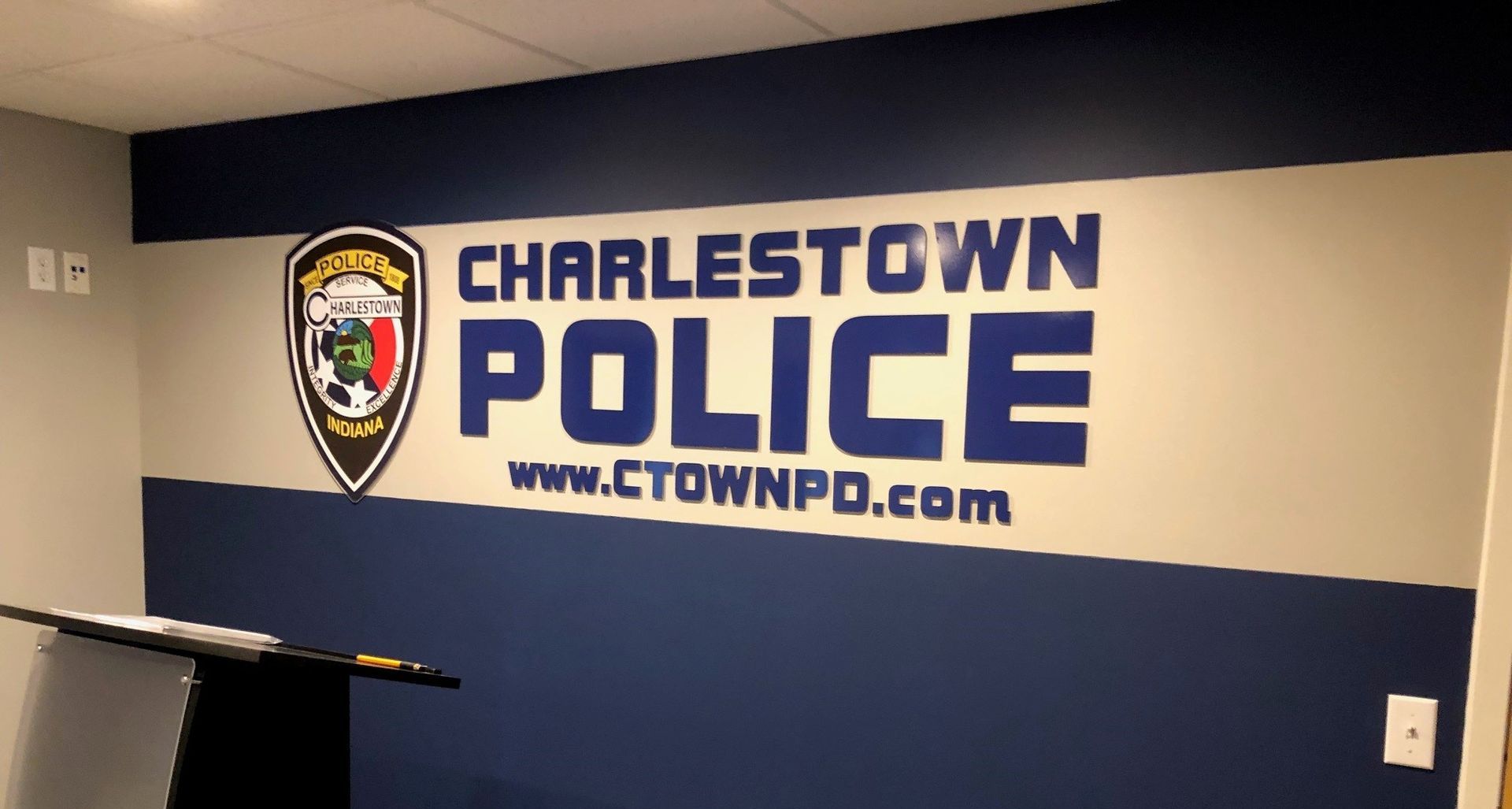 A charlestown police sign is painted on a wall